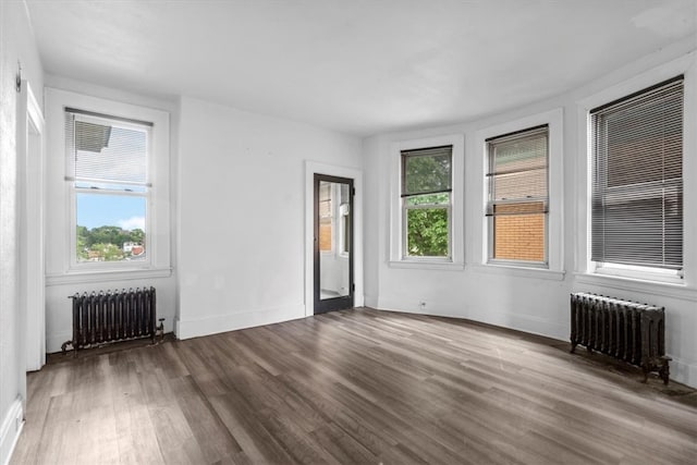 unfurnished room with wood-type flooring and radiator