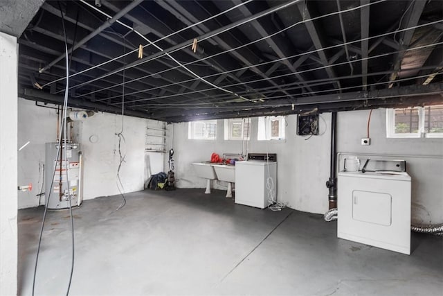 basement featuring washing machine and clothes dryer and gas water heater