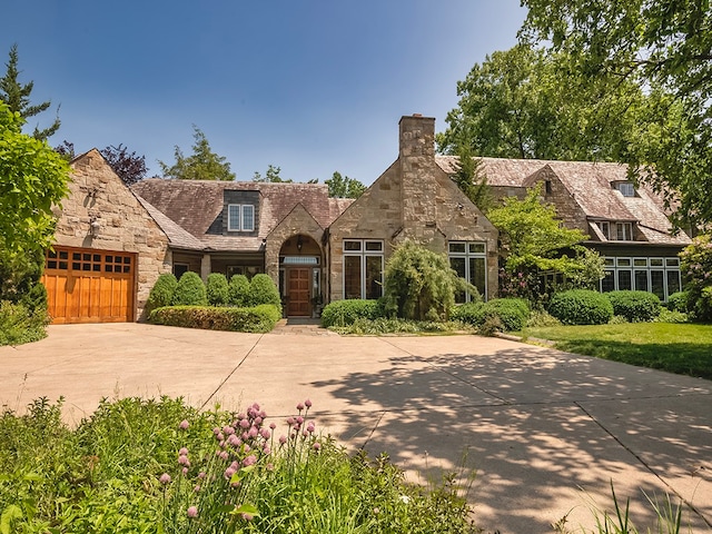 tudor-style house featuring a garage