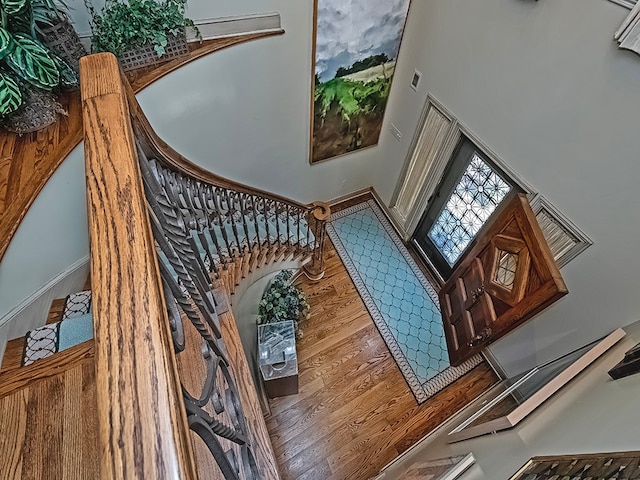 interior space featuring hardwood / wood-style floors and a high ceiling