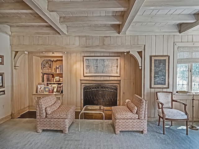 living area featuring carpet, beam ceiling, wood walls, and wood ceiling