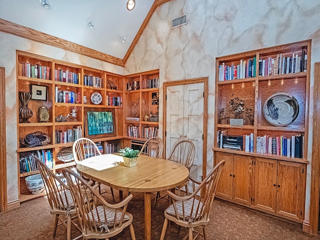 dining space with high vaulted ceiling