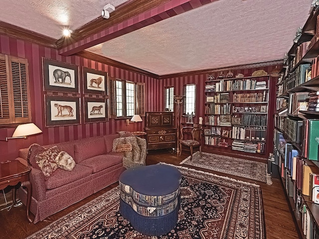 sitting room featuring ornamental molding, a textured ceiling, and dark hardwood / wood-style floors