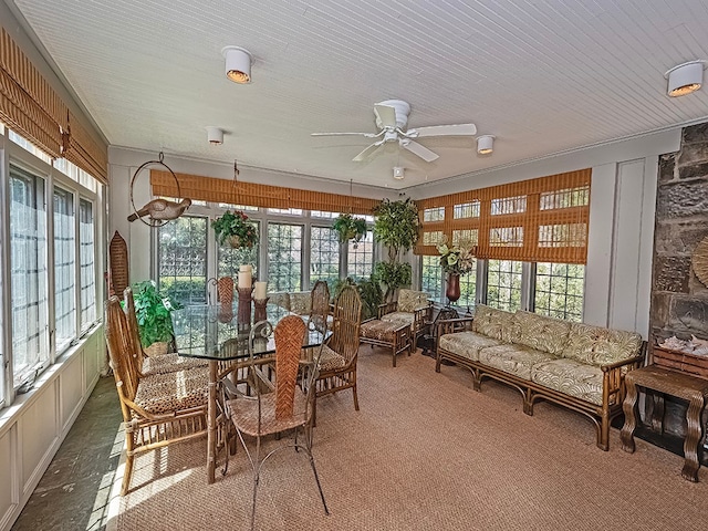 sunroom / solarium featuring ceiling fan