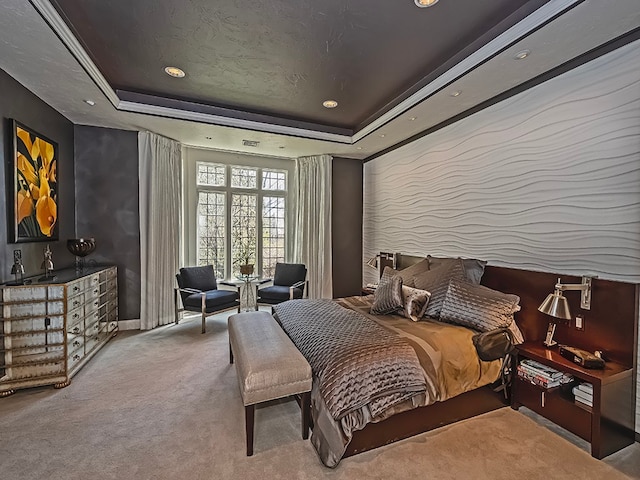 carpeted bedroom featuring a raised ceiling