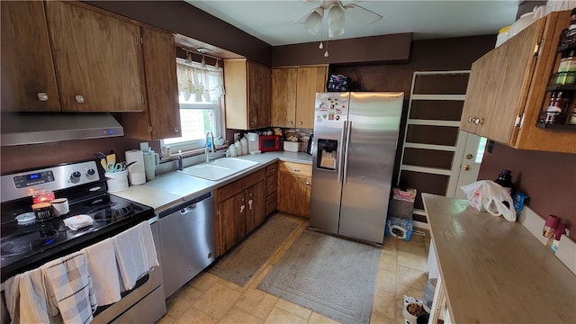 kitchen featuring ceiling fan, sink, light tile flooring, and appliances with stainless steel finishes