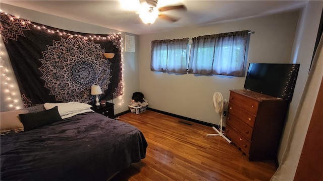 bedroom with ceiling fan and hardwood / wood-style flooring