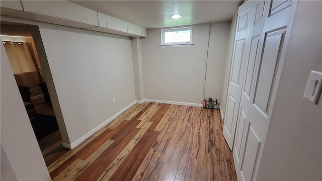 basement with light hardwood / wood-style floors