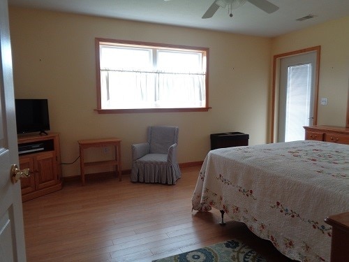 bedroom featuring wood-type flooring and ceiling fan