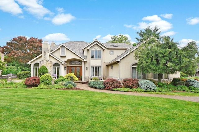 view of front facade with a front yard and french doors