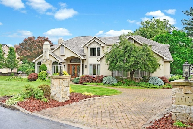 view of front of house featuring french doors and a front yard