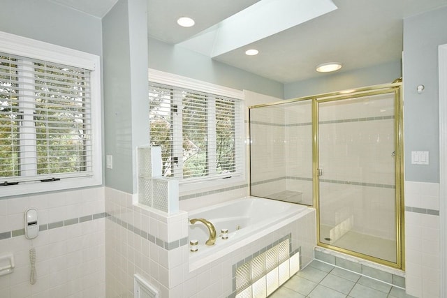 bathroom with independent shower and bath and tile patterned flooring