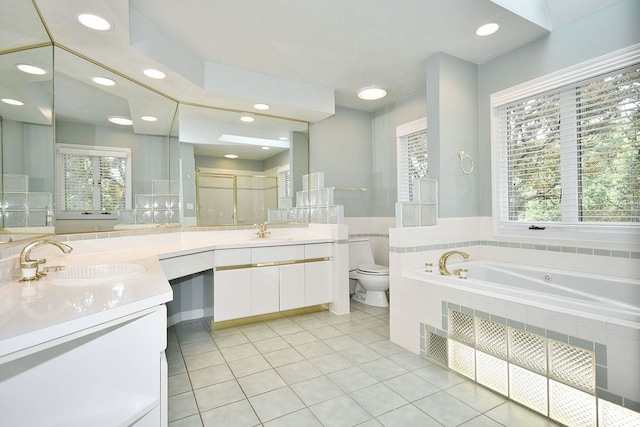 full bathroom featuring toilet, vanity, tile patterned flooring, and independent shower and bath