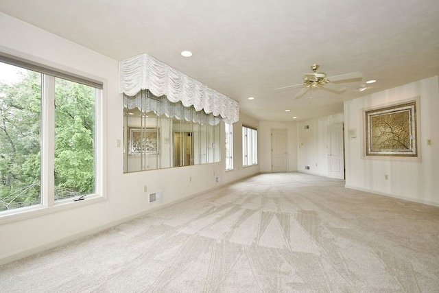 spare room with carpet floors and ceiling fan