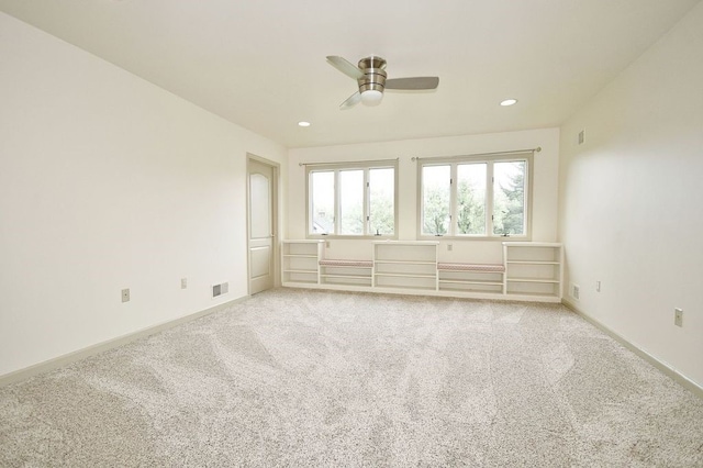 empty room with ceiling fan and light colored carpet