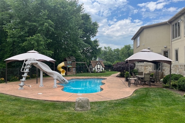 view of swimming pool with a playground, a water slide, a yard, and a gazebo