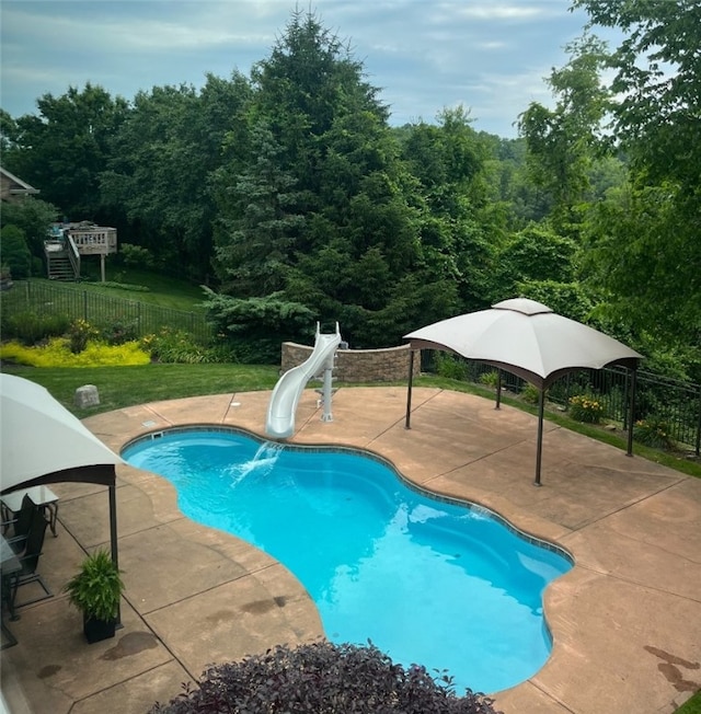 view of pool with a patio and a water slide