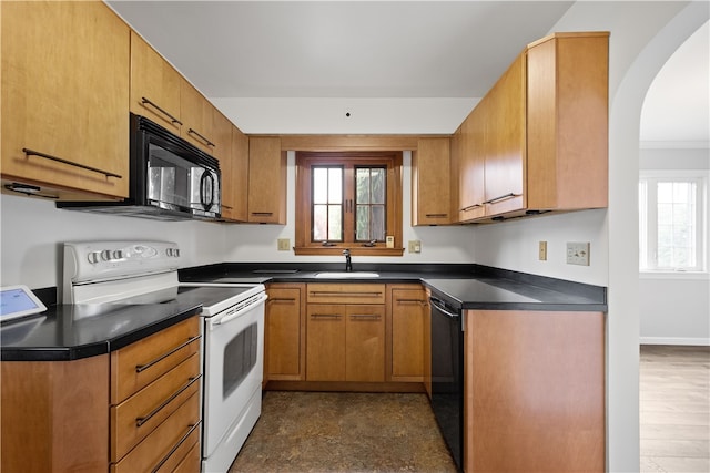 kitchen with sink, dark hardwood / wood-style flooring, black appliances, and a healthy amount of sunlight