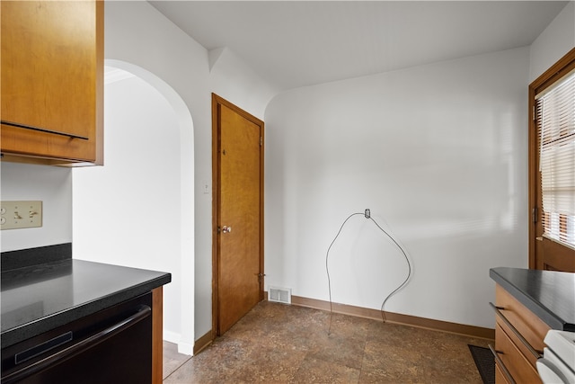 kitchen featuring light tile patterned flooring, a healthy amount of sunlight, and stove