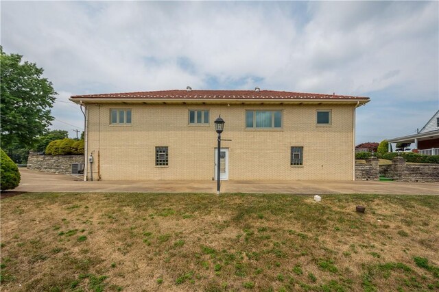 back of house featuring a patio area and a yard