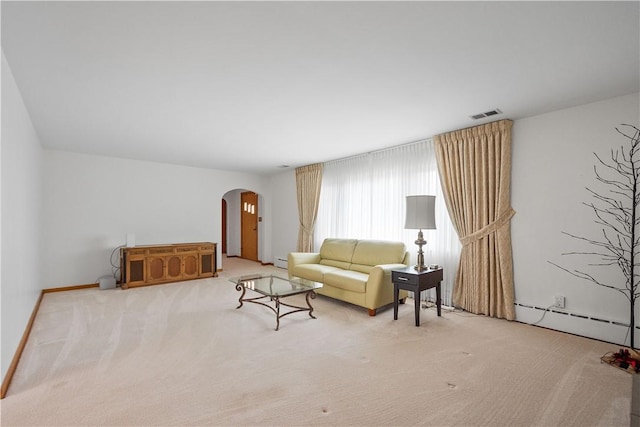 living room featuring light carpet and baseboard heating