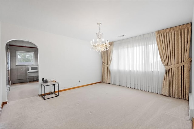 empty room featuring an inviting chandelier, carpet floors, and baseboard heating