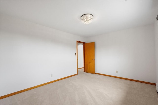 unfurnished room with light carpet