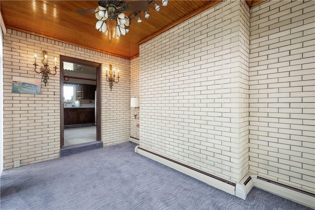 view of exterior entry with baseboard heating, ceiling fan, and a patio area