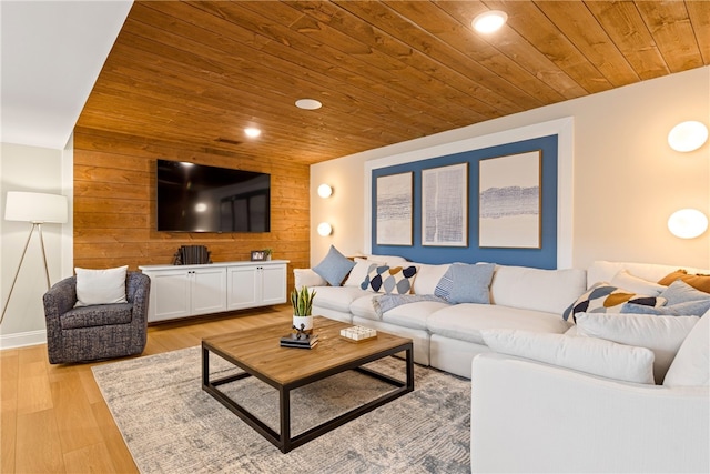 living room with wooden walls, light hardwood / wood-style flooring, and wood ceiling