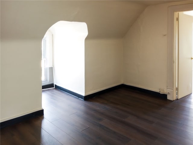 additional living space with lofted ceiling and dark wood-type flooring