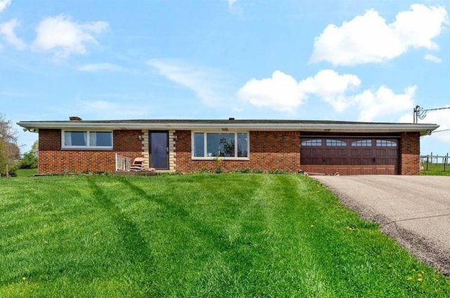 ranch-style home with a garage and a front lawn