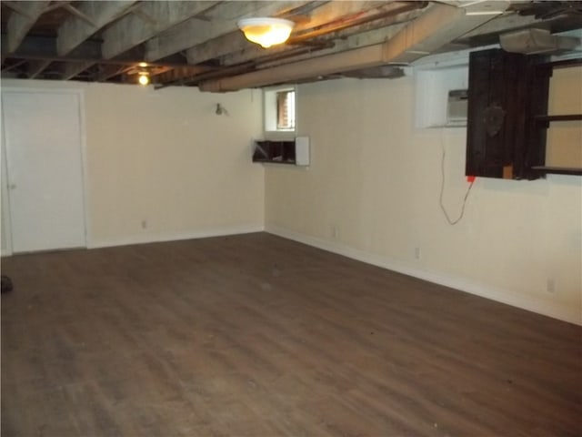 basement with dark hardwood / wood-style flooring