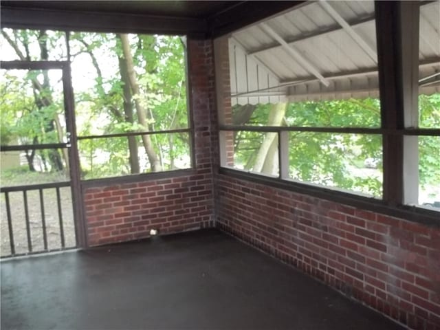 unfurnished sunroom with lofted ceiling