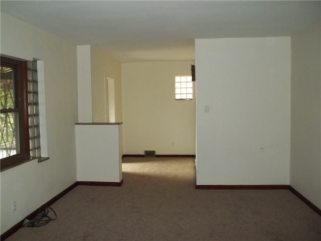 carpeted empty room featuring a healthy amount of sunlight