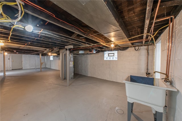 basement featuring sink and water heater