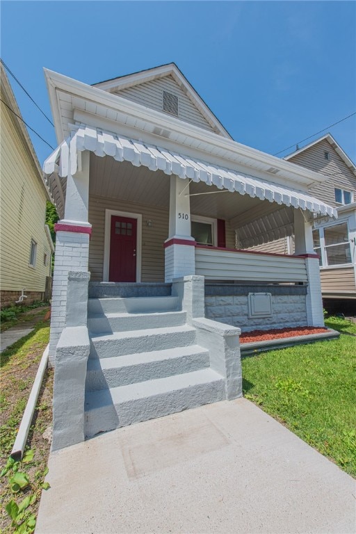 view of front of property featuring a porch and a front yard