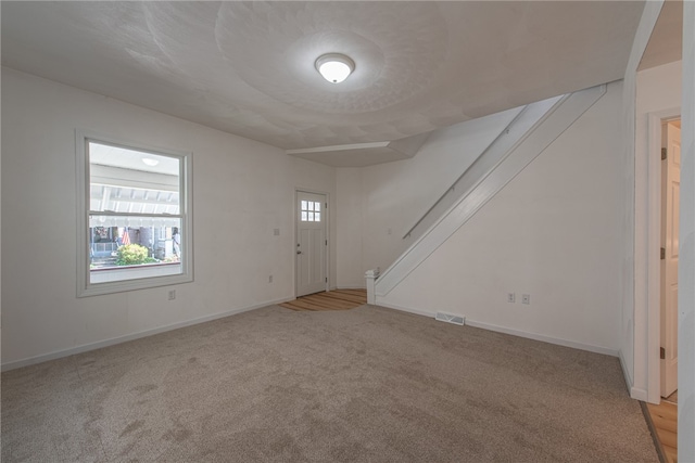 interior space with light carpet and a wealth of natural light