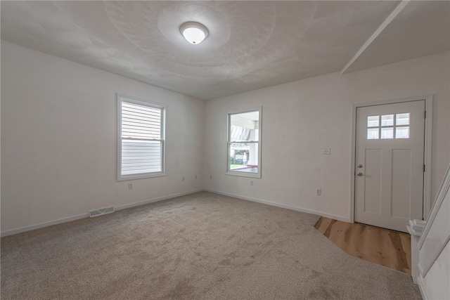 view of carpeted entrance foyer