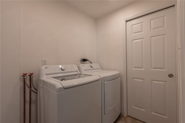 clothes washing area featuring washer and clothes dryer