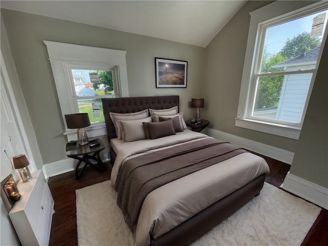 bedroom featuring vaulted ceiling and dark hardwood / wood-style floors