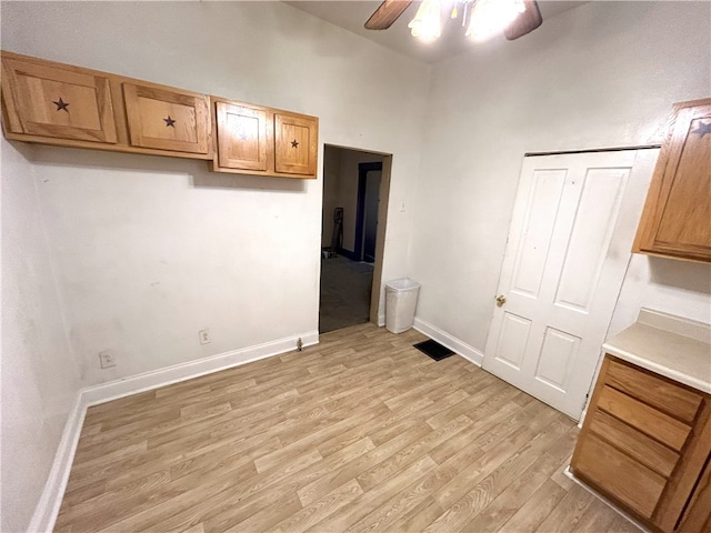 kitchen featuring ceiling fan and light hardwood / wood-style flooring