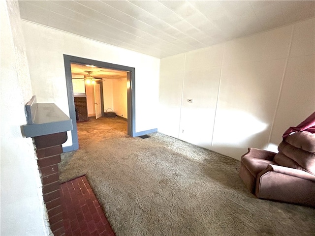 interior space with carpet flooring and ceiling fan