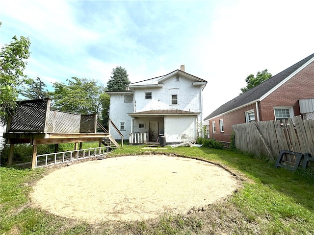 back of house with a lawn