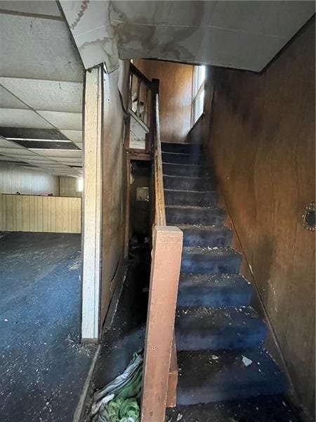 staircase featuring a paneled ceiling