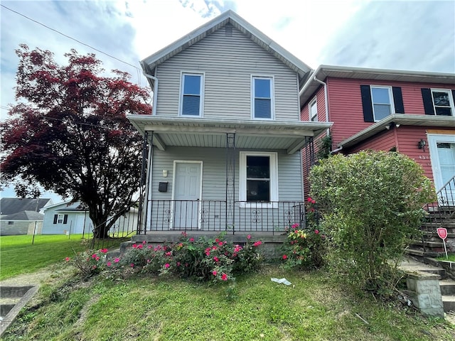 front of property with a front lawn and covered porch