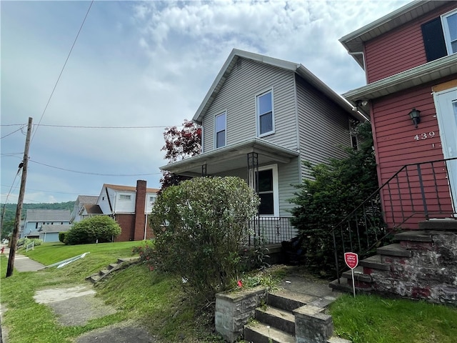 exterior space with a porch and a lawn