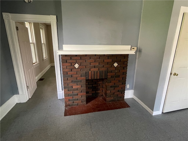 unfurnished living room featuring dark tile flooring