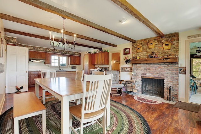 dining area with beam ceiling, a healthy amount of sunlight, and hardwood / wood-style flooring