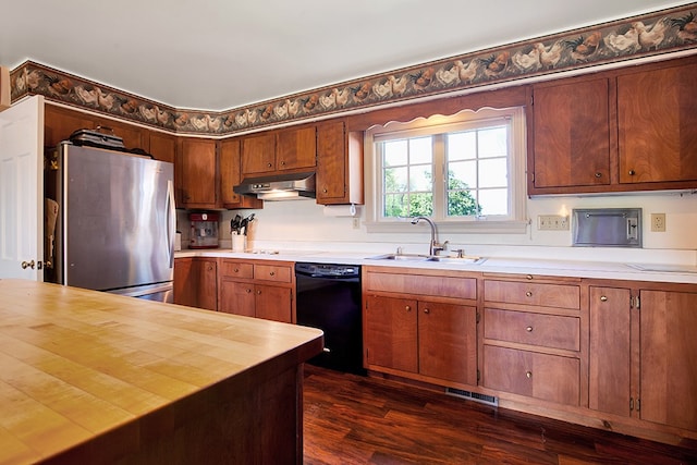 kitchen with black dishwasher, sink, butcher block counters, stainless steel refrigerator, and dark hardwood / wood-style floors