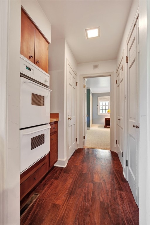 corridor featuring dark hardwood / wood-style floors